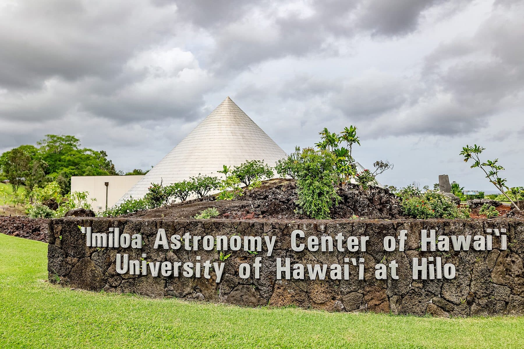 The ʻImiloa Astronomy Center sign and the center’s cone-shaped buildings in Hilo
