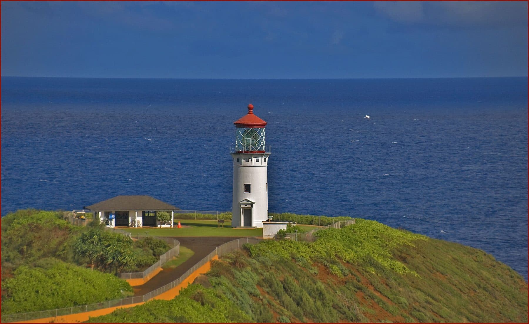 Kīlauea Point Lighthouse on its green headland above the ocean