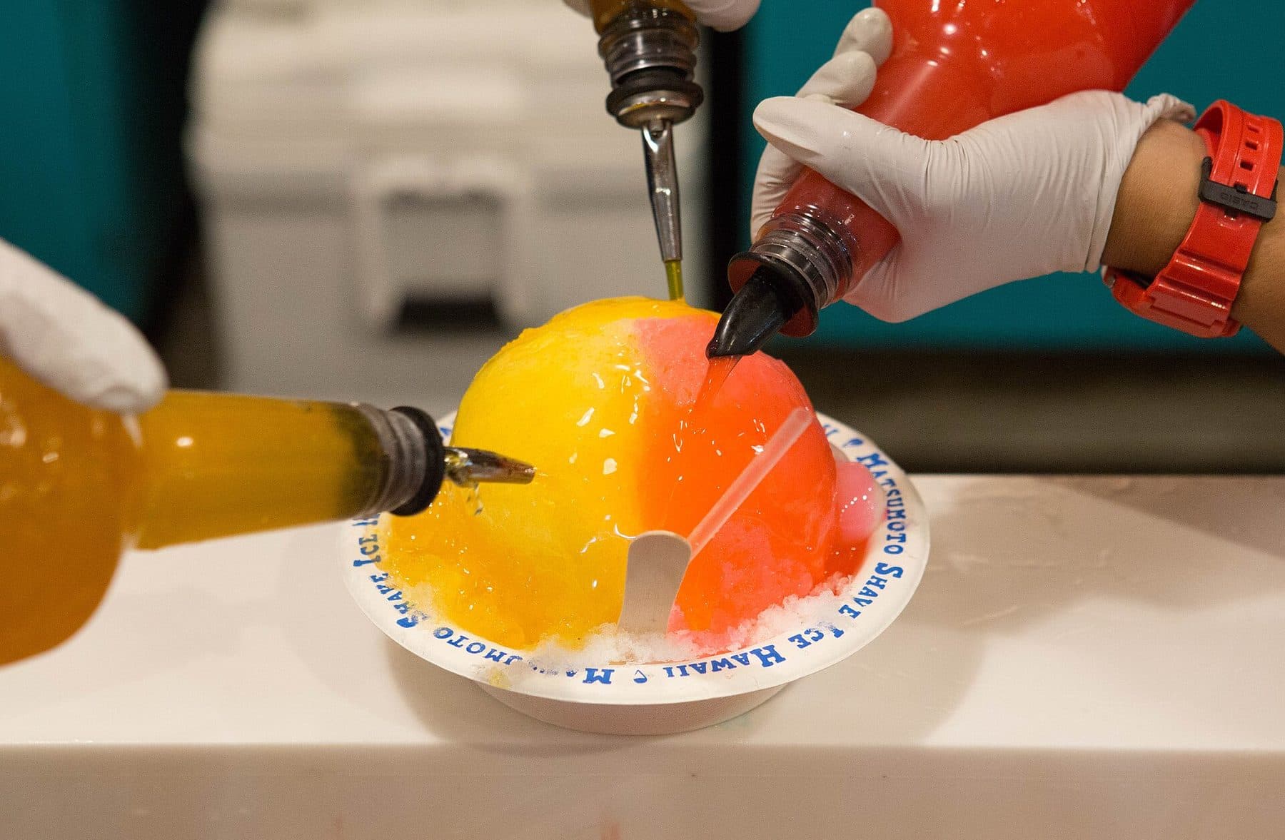 Syrup poured over shave ice in a Matsumoto Shave Ice bowl in Haleʻiwa