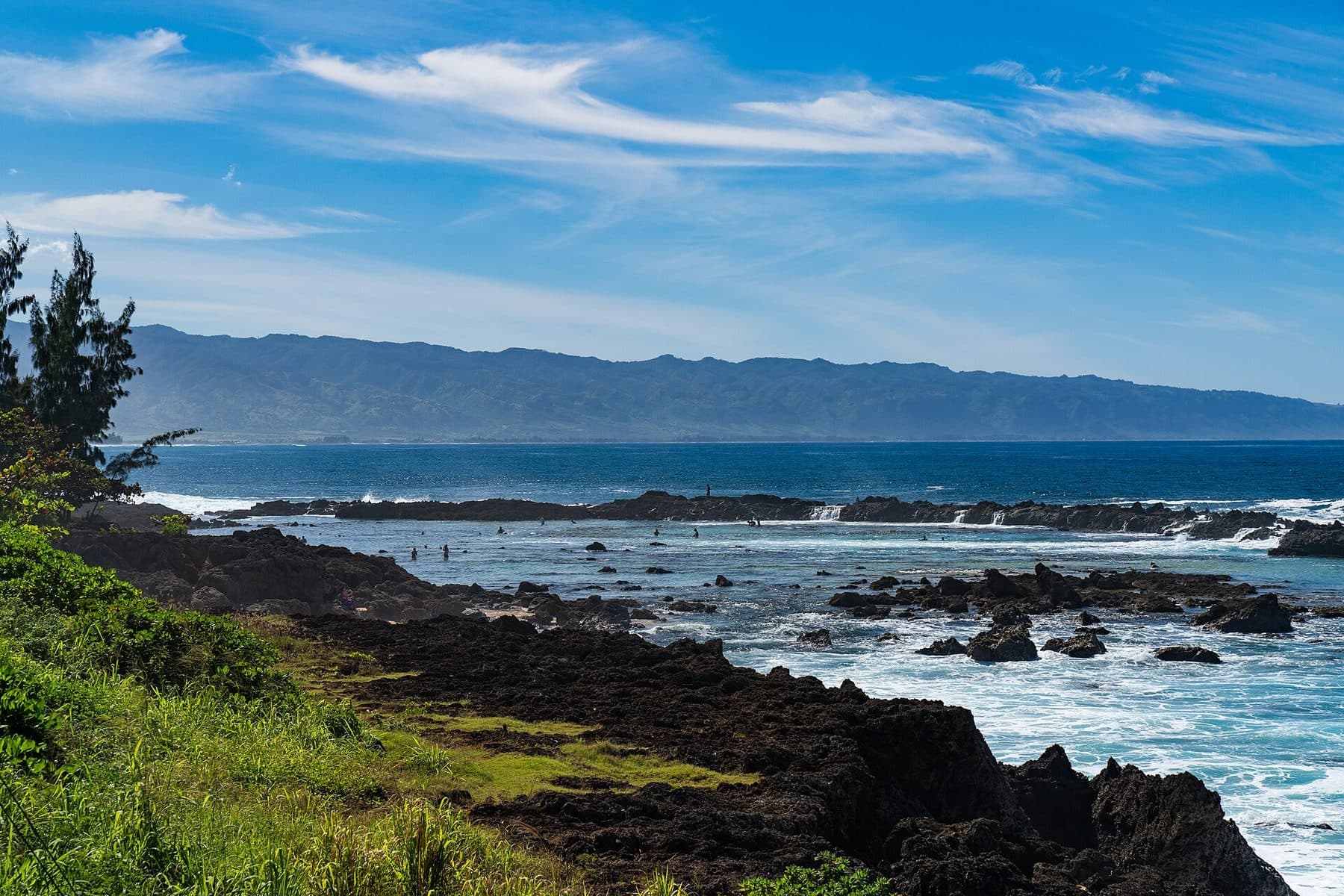 Lava-rock shoreline of Sharks Cove at Pūpūkea Beach Park on the North Shore