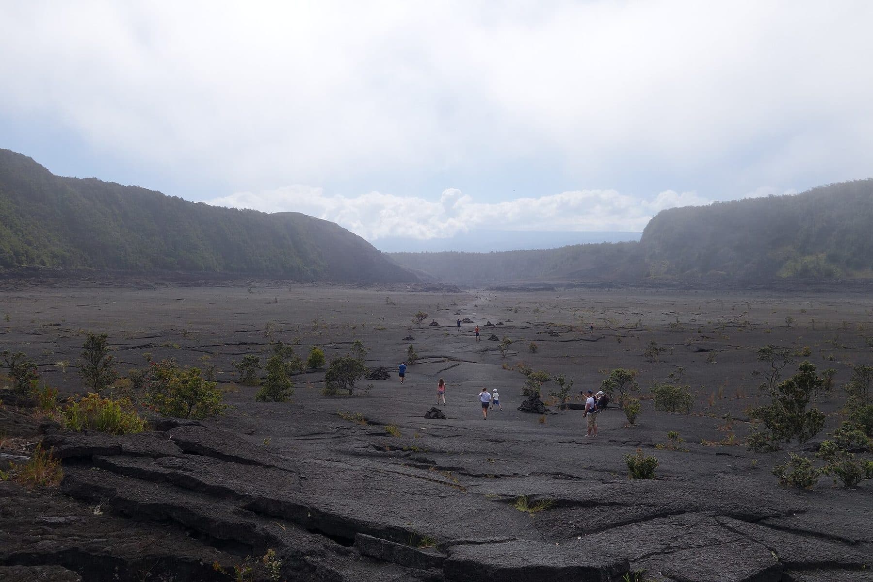 Looking across the hardened lava floor of Kīlauea Iki crater from the trail