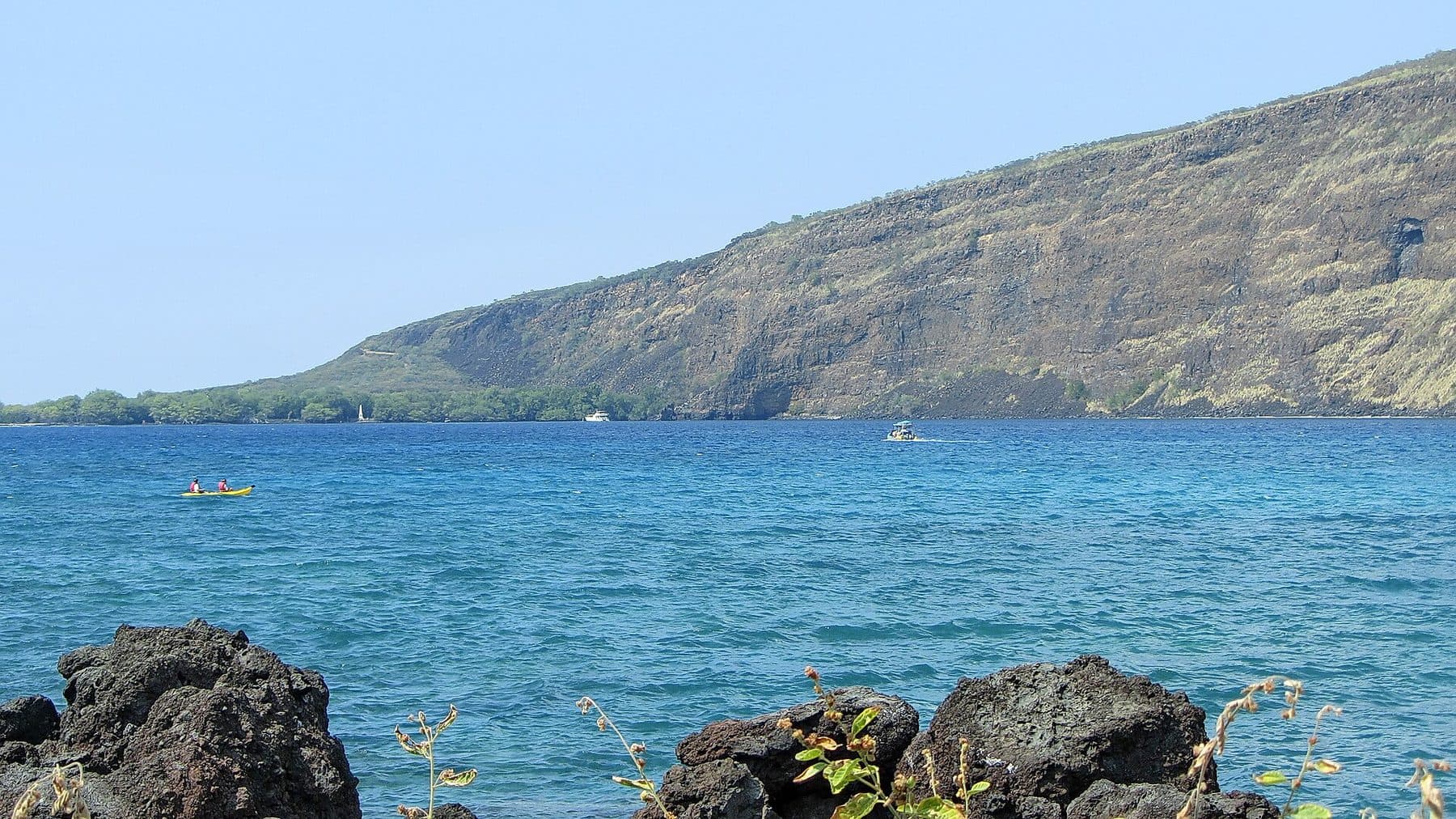 Kealakekua Bay’s blue water below its steep green cliffs